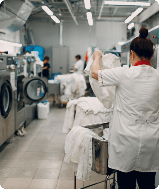 A Lady sorting clother for washing in a laundry shop